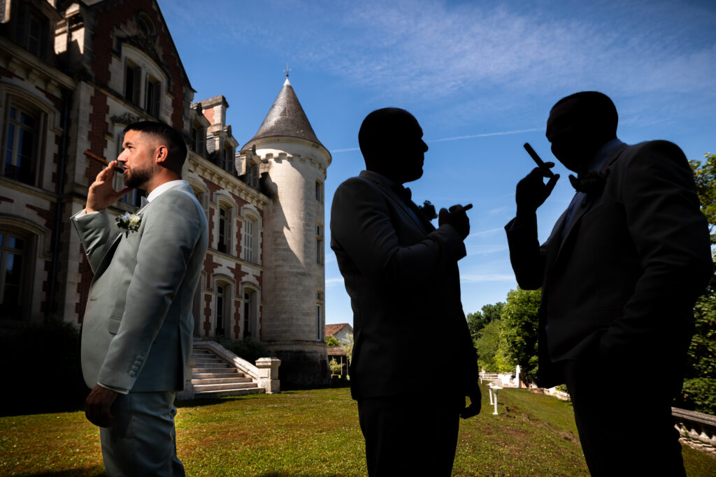 Portrait créatif du marié et de ses deux témoins derrière le château de la Pouyade sur la façade arrière
